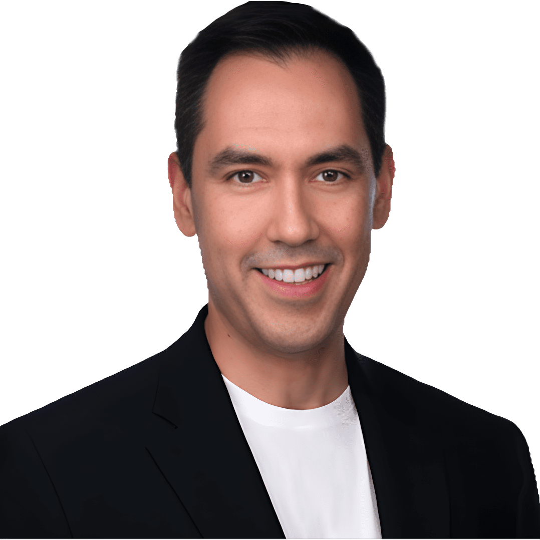 A man in black jacket and white shirt smiling.